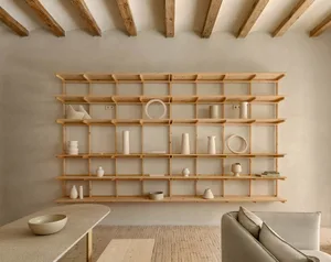 A minimalist shelf display featuring various wooden objects in a serene, neutral-toned room.