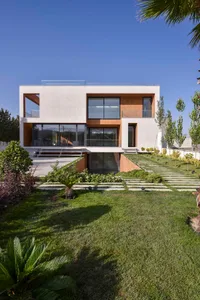 A modern house exterior with concrete and glass materials.