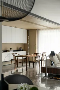A modern living and dining room featuring marble surfaces and contemporary furniture.