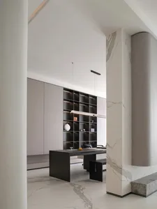 A modern minimalist office space featuring a combination of marble and concrete materials.