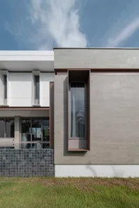 A modern residential building with concrete and glass materials.