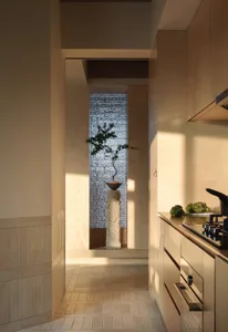 A minimalist kitchen with wooden cabinets and porcelain countertops.
