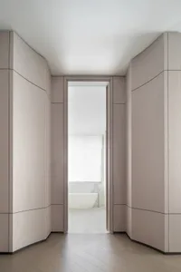 Modern bathroom view showing a white bathtub and light-colored walls and flooring.
