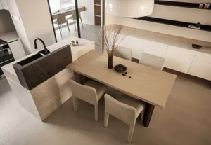 Modern kitchen featuring marble countertop and dining area with wooden table and chairs