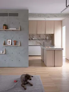 A modern residential kitchen featuring wood and marble materials.
