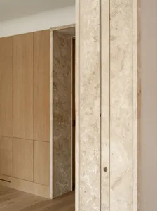 A modern interior space with marble features and warm lighting.