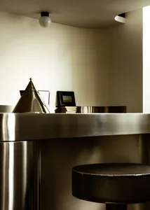A sleek, minimalist kitchen with metallic finishes and a modern design.