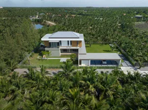 Modern residential house with a combination of concrete and glass exterior materials.