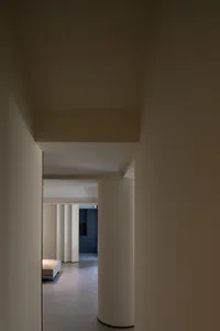 A modern interior space featuring concrete columns and minimalistic design.