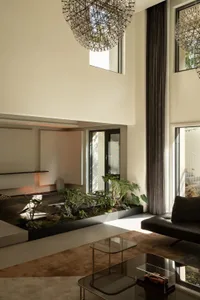 Modern living room featuring concrete, glass, and metal materials.