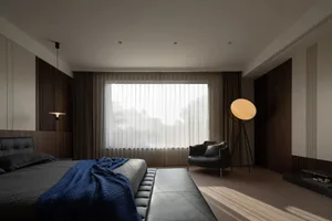 A modern bedroom featuring a bed with striped coverings, a textured wooden headboard, and a leather bench.