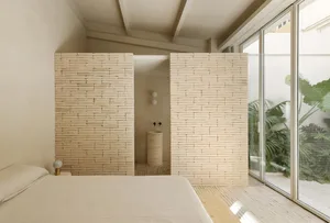 Modern minimalist bedroom with brick walls and natural light.