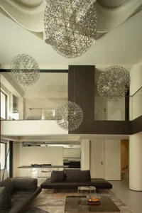A modern living room with glass sphere chandeliers