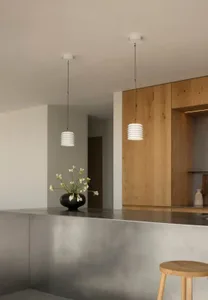 A modern minimalist kitchen featuring a concrete bar counter and wooden cabinets.