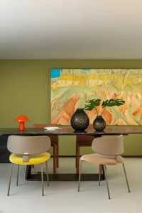 A contemporary dining room featuring a marble table and fabric-covered chairs.