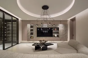 A modern living room featuring marble surfaces, glass panels, and metallic accents.