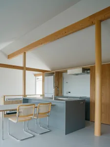 Minimalist kitchen design featuring concrete countertops and wooden elements