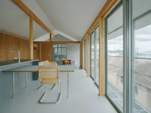 Modern, minimalist kitchen featuring glass and steel materials.