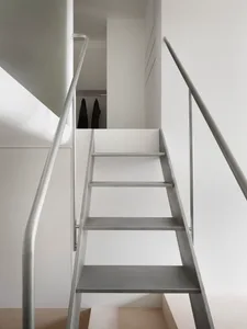Concrete stairs with metal handrails in a minimalist interior