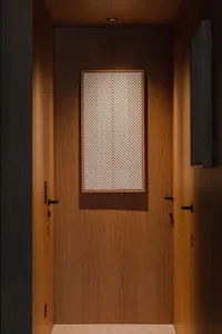 Modern entryway featuring a wooden door with a textured geometric pattern.