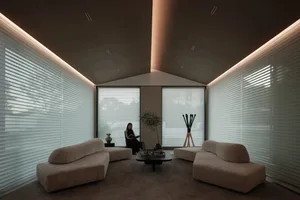 A modern living room with beige upholstered furniture.