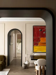 A modern residential interior featuring a concrete wall, wood flooring, and fabric furnishings.