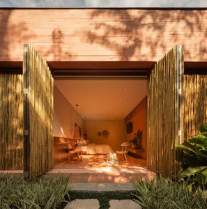A bohemian-style bedroom with wooden panels made of bamboo.