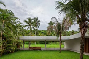 Modern residential space featuring concrete furniture and greenery.