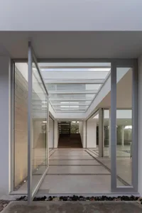 Modern residential interior featuring concrete flooring and a skylight.