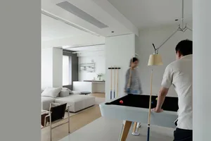 Minimalist living room featuring modern furniture, sleek design, and a pool table.