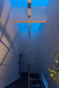 A modern interior design featuring concrete walls and flooring.
