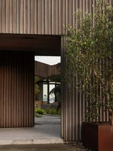 An architectural exterior featuring modern design elements and timber siding.