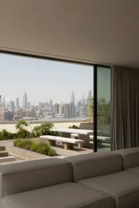 Contemporary living room featuring concrete and marble with a city skyline view.