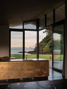 Modern minimalist kitchen featuring metallic cabinets and marble countertops.