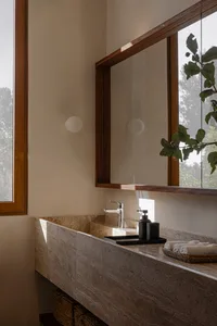 Minimalist bathroom with a marble counter, sink, and faucet.