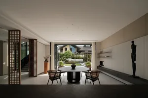 Modern minimalist residential interior featuring concrete, glass, and wood materials