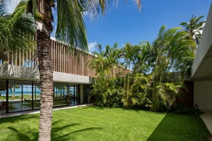 Modern house exterior with greenery and palm trees