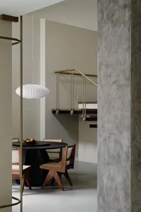 A modern interior design featuring concrete walls and wooden furniture.