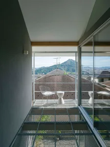 Modern interior design with metal furniture and a view of mountains through a glass wall.