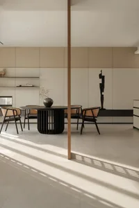 Minimalist dining room with a modern table, chairs, and vases in a contemporary interior design
