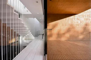A modern interior featuring wooden tiles and stairs.