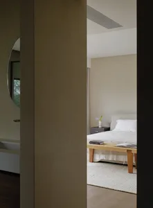 Minimalist bedroom with modern furniture and light colors.