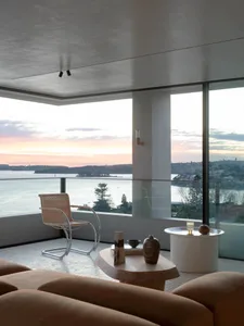 Modern minimalist living room featuring a glass and concrete design