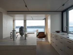 Modern kitchen with concrete countertops and a view of the water.