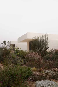 A modern residential exterior featuring reclaimed stone materials.