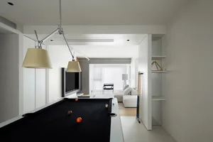 Modern minimalist living room with concrete flooring, metal accents, and sleek furniture.