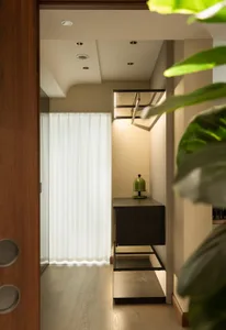 Modern closet interior with a wooden cabinet and glass shelves.