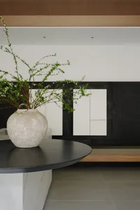 Modern living room with minimalist design featuring concrete elements.