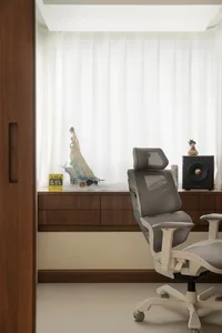 A minimalist home office with modern furniture, wooden accents, and glass surfaces.