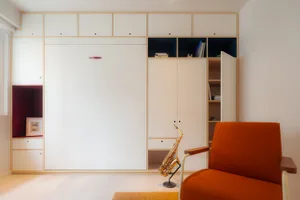Modern minimalist armchair in a contemporary residential interior setting.
